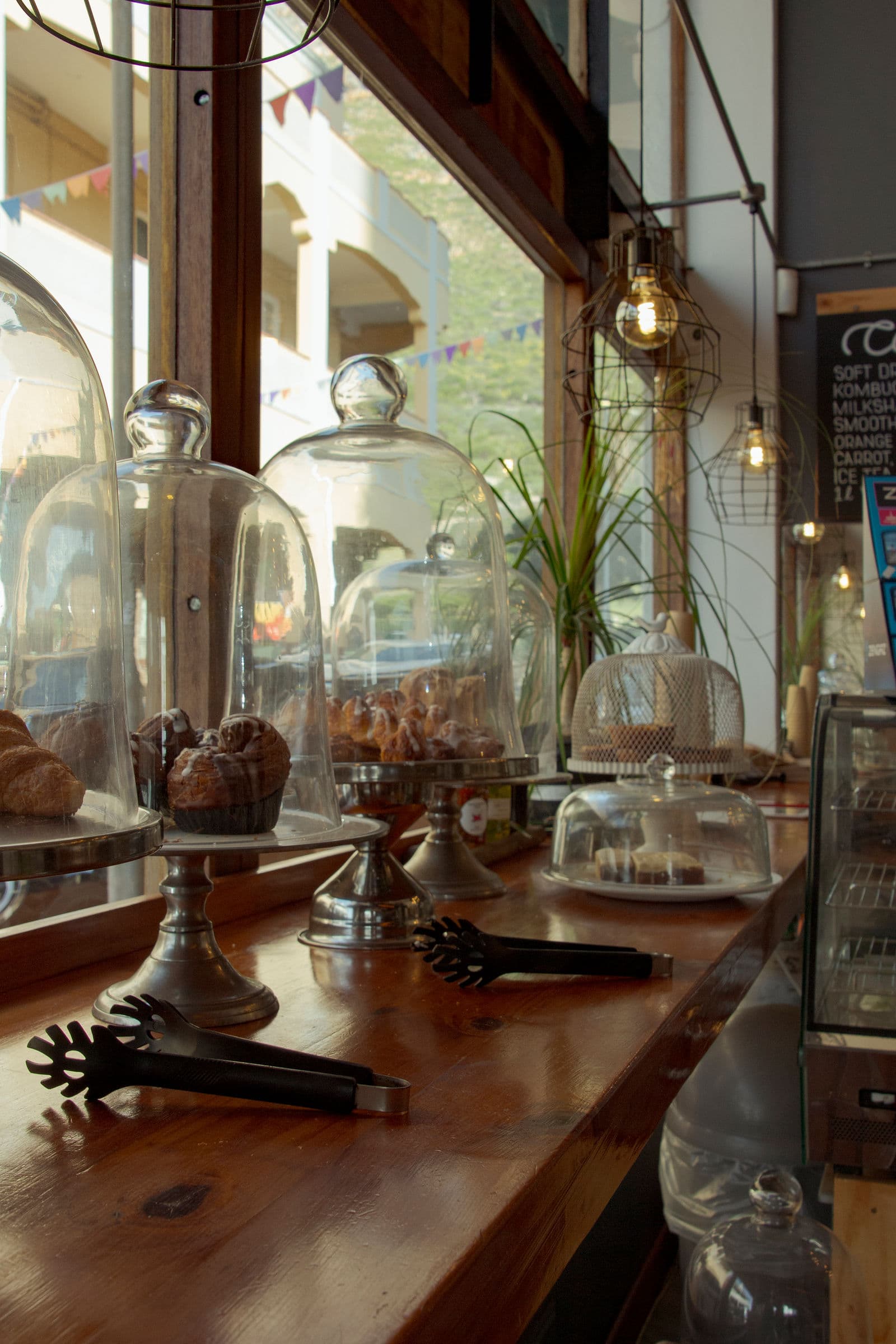 Pastries under glass on the counter at Empire Cafe, Muizenberg