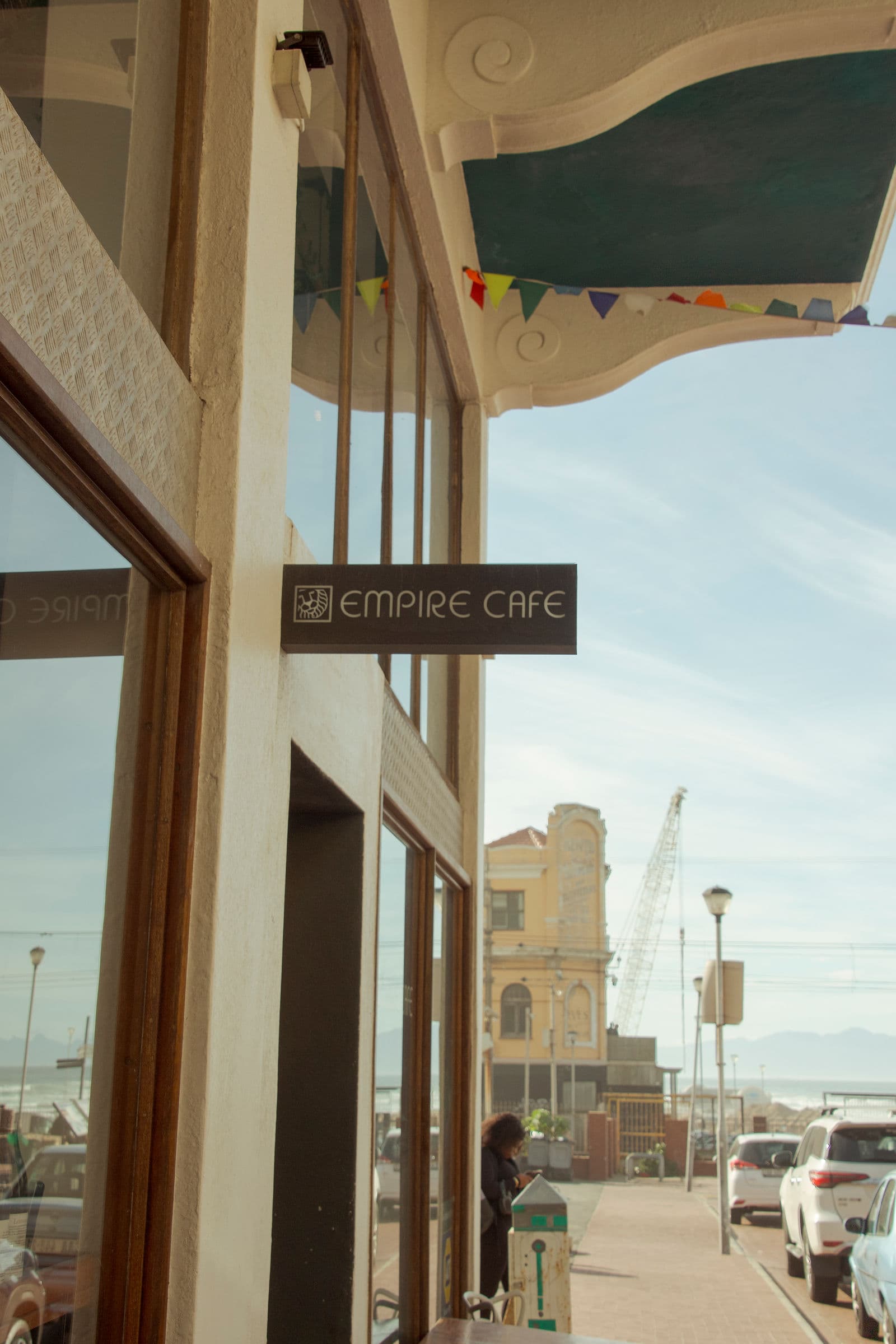 The Empire Cafe hanging sign on York Road, Muizenberg